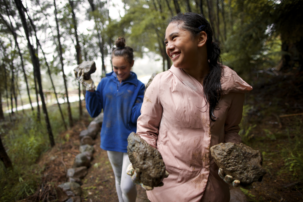 Young Women carrying rocks for service project